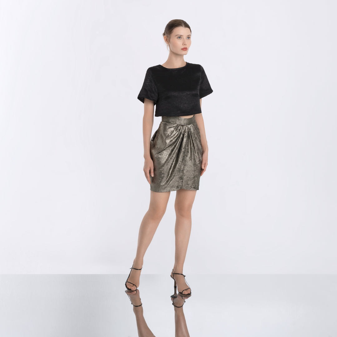 Metallic gold pleated skirt with sculptural silhouette and elegant shine, part of Lola Clavel's designer womenswear collection