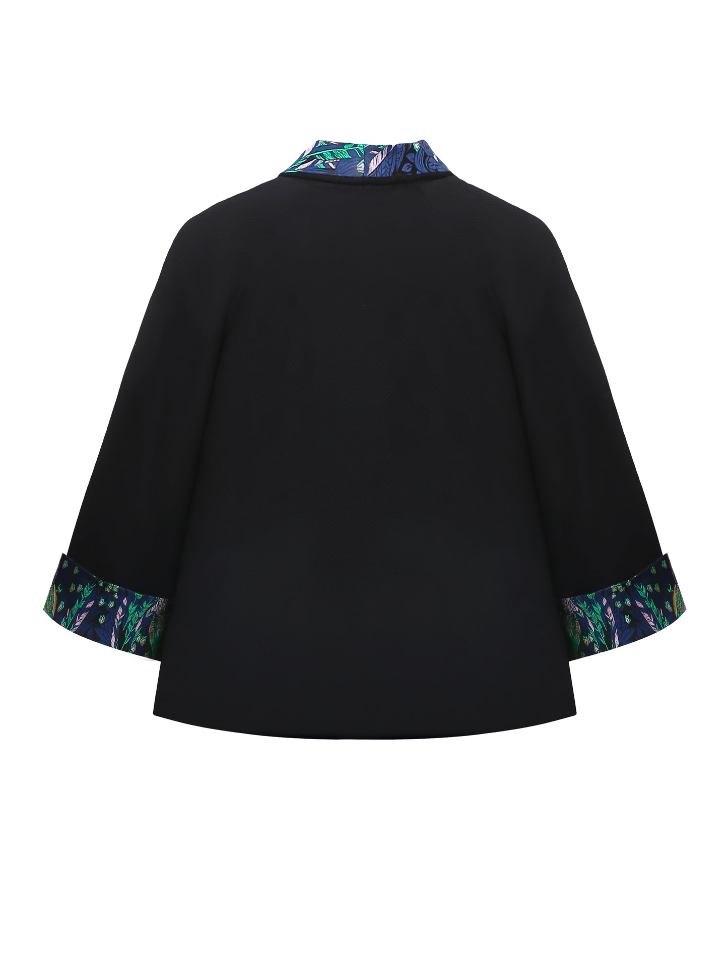 Back view of the reversible kimono jacket in black brocade showing the elegant silhouette and subtle woven texture