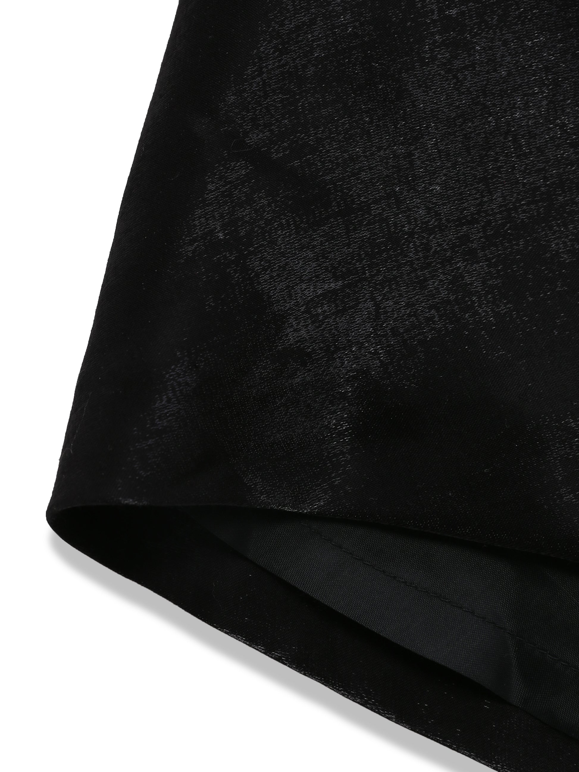 Detailed close-up of metallic black draped fabric, soft sheen and fluid texture in designer skirt by Lola Clavel