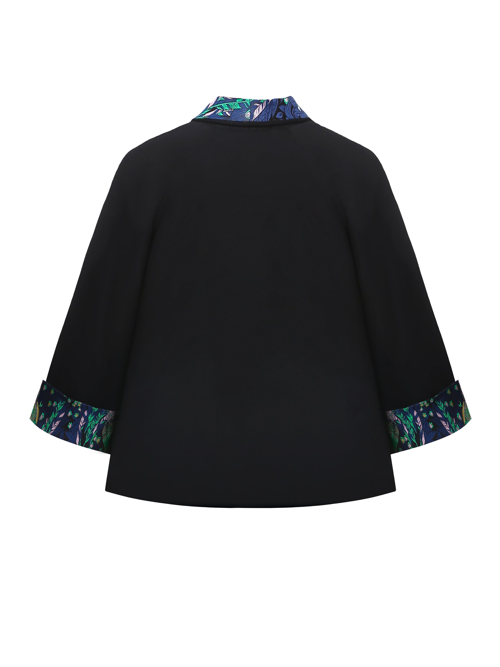 Back view of the reversible kimono jacket in black brocade showing the elegant silhouette and subtle woven texture