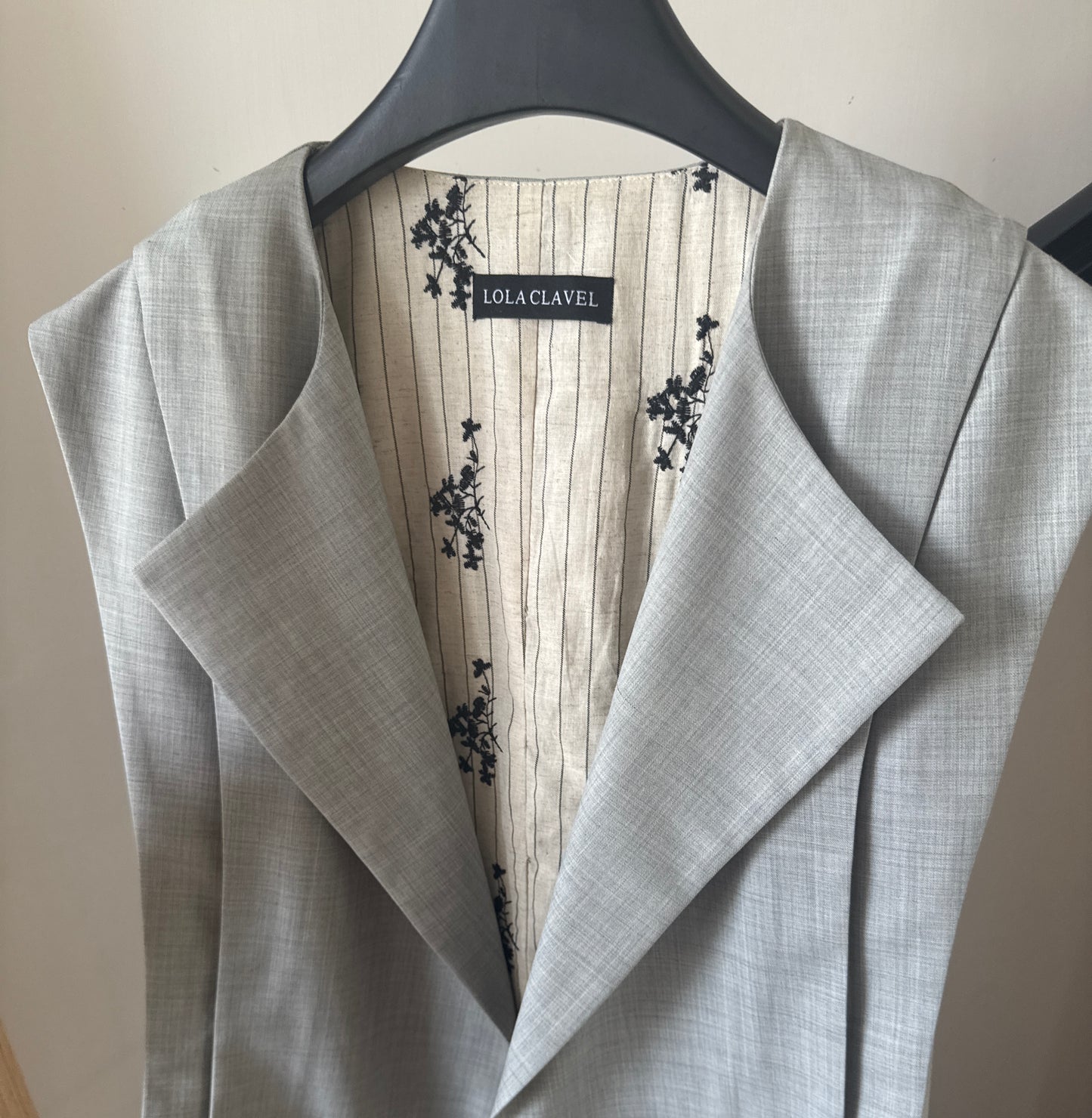 Close-up of the Jeanne d’Arc vest floral silk lining, revealing the contrast between structure and softness.